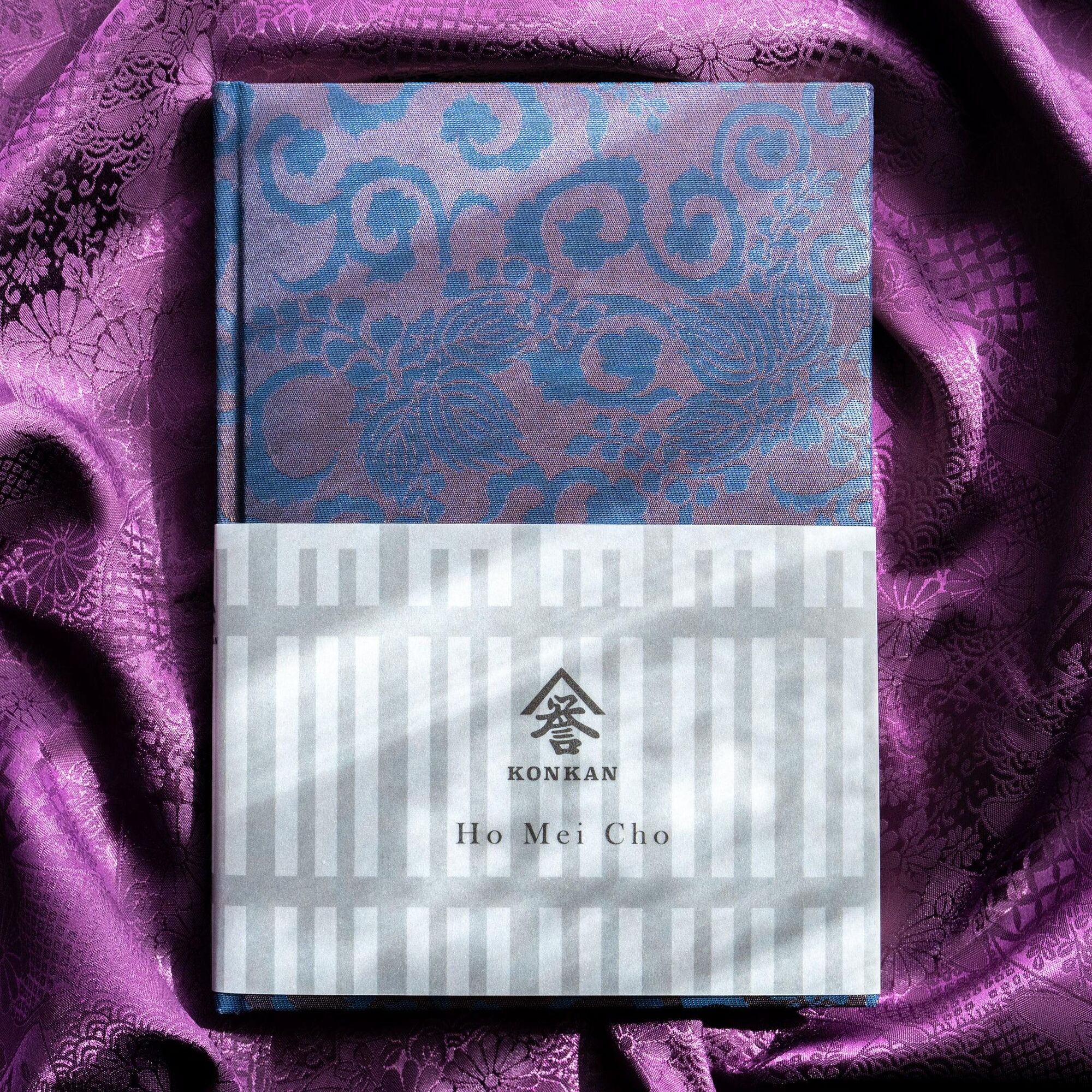 Oni Kiri Nishijin Silk Homeicho Notebook by Konkan Shoten, on purple silk fabric